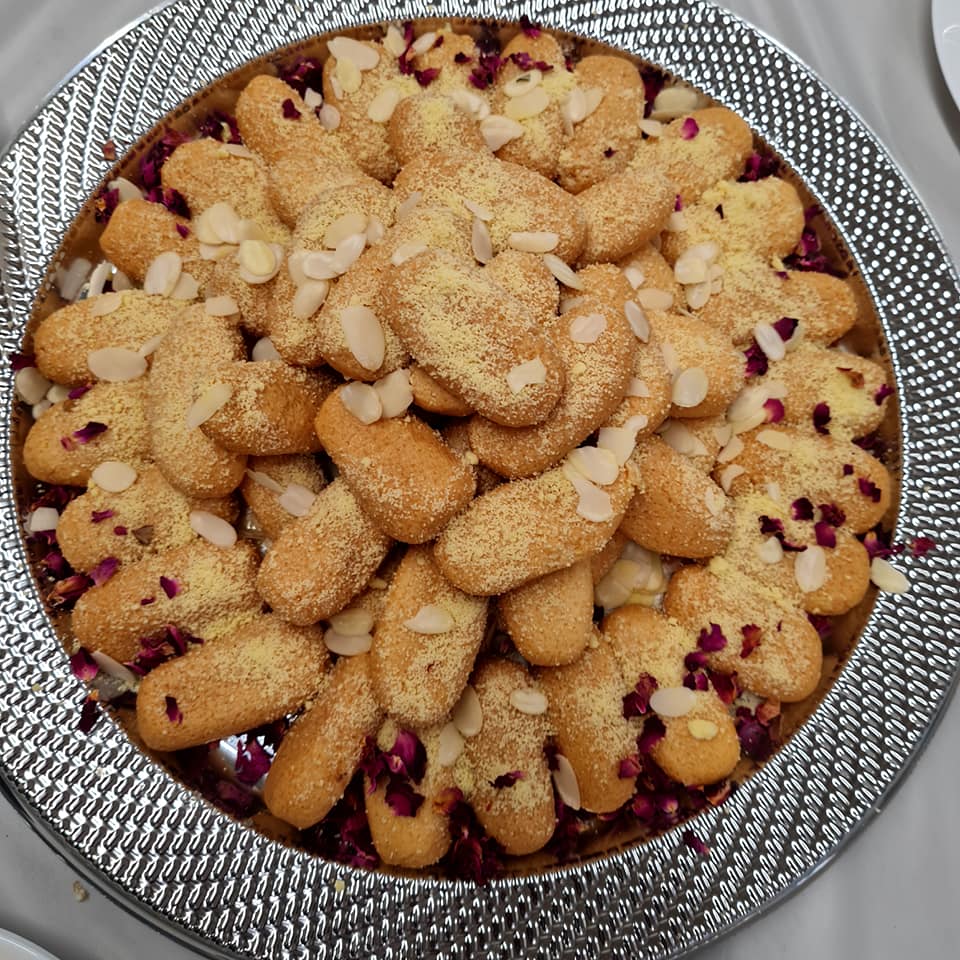 Traditional Bangladeshi sweets with rose petals and almonds